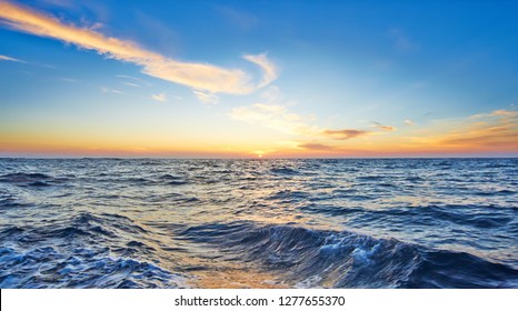 Wake Of The Ship In The Sea Against Sunset And Cloudy Sky