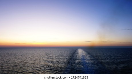 Wake Of A Ship In The Sea At Sunset