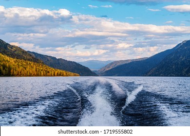 The Wake Of The Stern Of A Motor Boat Sailing On A Mountain Lake. Fall. Russia, Altai Republic, Lake Teletskoye