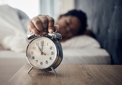 Wake Up, Alarm Clock Or Woman Sleeping In Bed In The Morning After Resting Pressing A Snooze Button. Sleepy Blur, Hand Or Tired Person At Home Getting Up From Nap In Bedroom Ready To Start A New Day