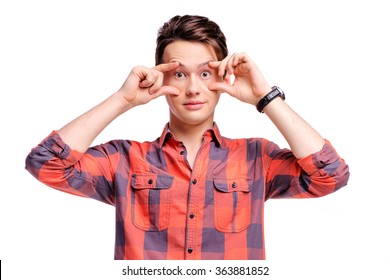 Wake Up! Funny Studio Portrait Of Young Handsome Man Trying To Open His Eyes With Fingers. Isolated On White.