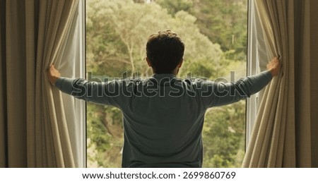 Wake up, window and back of man in hotel room for morning routine, accommodation getaway and relax. Curtain, hospitality and view with person in house rental for comfortable, trip and sunrise