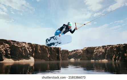 Wakeboarder making tricks on the river. Wakeboarding. Water sports. - Powered by Shutterstock