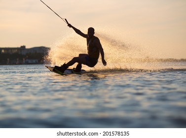 Wakeboarder making tricks on sunset