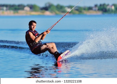 Wakeboarder surfing across a lake - Powered by Shutterstock