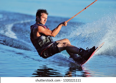 Wakeboarder surfing across a lake