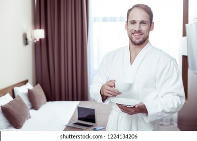 Waking In Hotel. Bearded Blonde-haired Man On Business Trip Feeling Relieved While Waking Up In Hotel Room