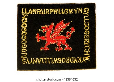 WALES - CIRCA 1960: An Embroidered Badge Printed In Wales Showing An Image Of The Welsh Dragon With The Longest Place Name Round The Border, Circa 1960