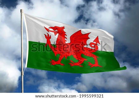 Wales flag on sky and cloud background. National symbols of Wales. Flag of Wales.