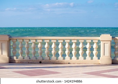 walk along the promenade with a parapet on a Sunny windy day by the ocean - Shutterstock ID 1424194886