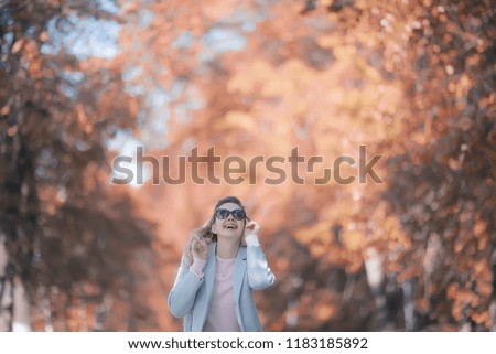 Similar – Image, Stock Photo Low angle view of blonde white girl posing in the forest with trees in the background.