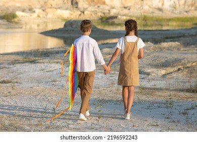 Walk Of Children 8-9 Years Old With A Kite In The Mountains.