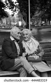 Walk. Elderly Couple Talking On A Park Bench. Black And White. True Love.