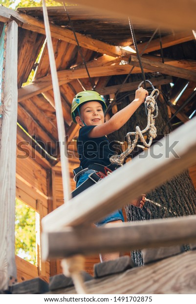  walk on\
a rope bridge in an adventure rope\
park