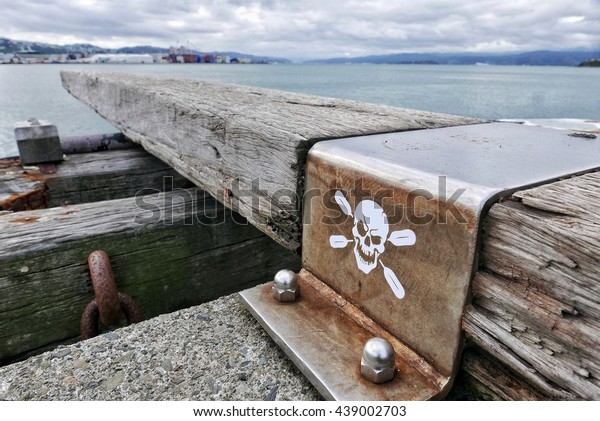 \'Walk the plank\' diving board with skull and\
crossbones, in Wellington, New Zealand\
