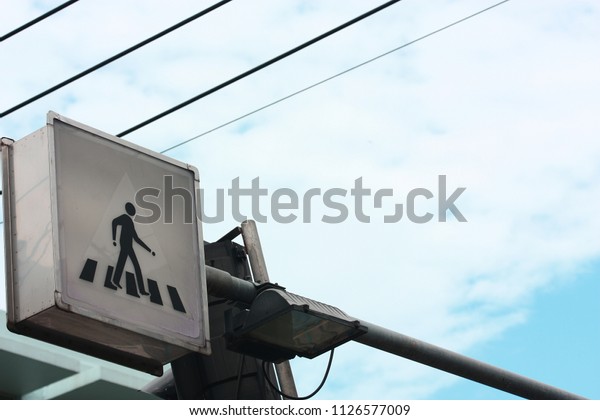 walk sign on\
pole