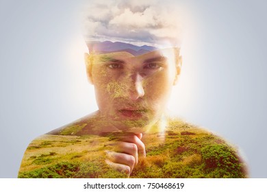 Walk through mind. Portrait of  perplexed  bighearted calm fellow  who gazing at the camera and holding his hand under chin posing against grey background 