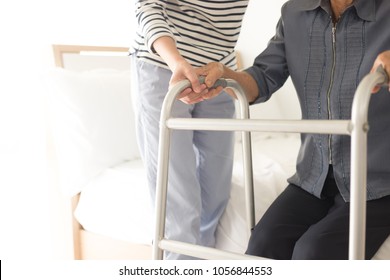 Walk Training And Rehabilitation Process, Stroke Patient Use Walker With Care Giver