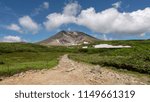 The walk way on Asahidake with Asahidake peak under blue cloudy sky, Asahikawa, Hokkaido, Japan