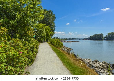 Walk Way On River Side Close To The Water. Fraser River Side Path In Vancouver, British Columbia. Peace Of Mind View.