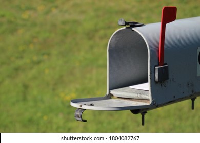 Walker, Minnesota-August 27, 2020: Closeup Of Rural US Mail Postal Service Box With Door Open, Letters Inside And Red Flag Raised