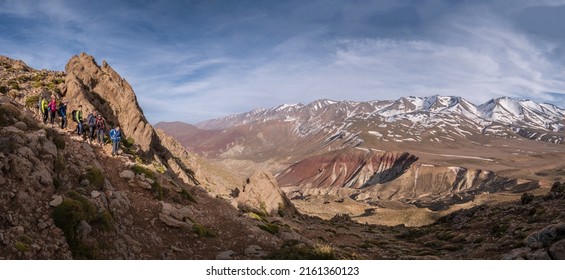 walkers descending to the Tarkeddit plain, M Goun trek, Atlas mountain range, morocco, africa