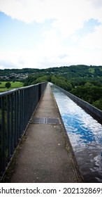 Walking along Pontcysyllte Aqueduct with canal. It is the highest canal aqueduct in the world. Portrait orientation photo.