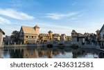 Walking area with shops and restaurants in United Arab Emirates. Riverland, Dubai. Houses and bridge in style of medieval Europe.