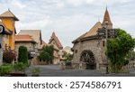 Walking area with shops and restaurants in United Arab Emirates. Riverland, Dubai. Houses and watermill in style of medieval Europe.