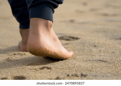 Walking bare feet on sandy beach - Powered by Shutterstock