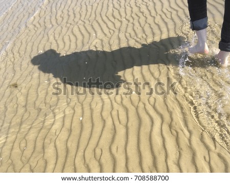 Walking with bare foot along the shore