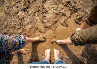 Walking Barefoot Through Muddy Road In Nature. Barefoot Trail. Shoeless Womens Legs. Grounding, Or Earthing, Making Contact With The Earth. Bare Feet