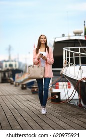 Walking Beautiful Young Woman Holding Coffee Cup And Smiling