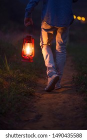 Walking Carrying A Lit Camping Lantern