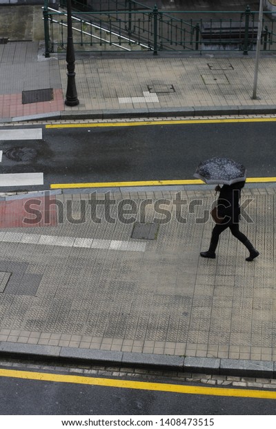 Walking in the city under the\
rain