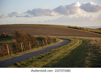 A walking and cycling path in the South Downs National Park with clouds and good weather in Brighton, UK