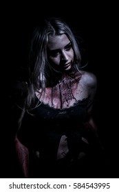 Walking dead woman over black background - Shutterstock ID 584543995