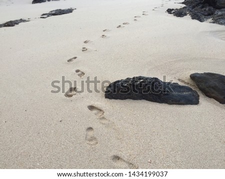 Walking footprints on the clean beach in the morning, Thailand.