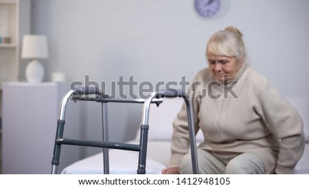 Similar – Senior woman in a wheelchair alone