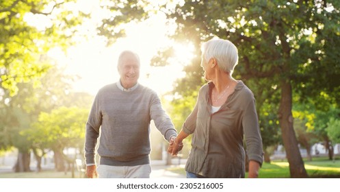 Walking, holding hands and a senior couple outdoor at a park with a love, care and support. Elderly man and woman in nature to follow on a walk, quality time and happy marriage or healthy retirement - Powered by Shutterstock