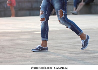 walking man in ripped jeans