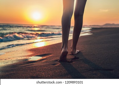 Walking On The Beach In Sunset Time