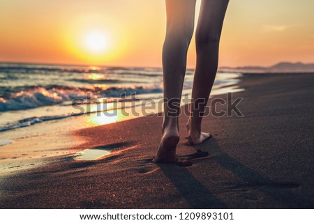 Walking on the beach in sunset time