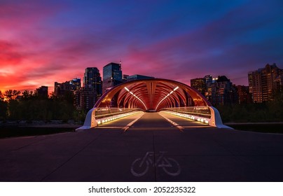 Walking on the illuminated Peace bridge at sunrise
