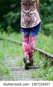 Walking on old abandoned railway, legs in colorful tights