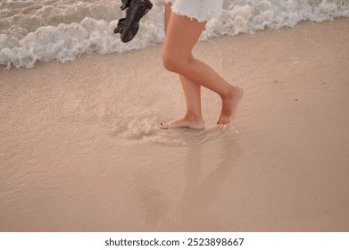 Walking on a white sand beach. Barefoot on the beach. Low angle woman walking barefoot. Close-up of woman's feet walking in sand on the beach. - Powered by Shutterstock