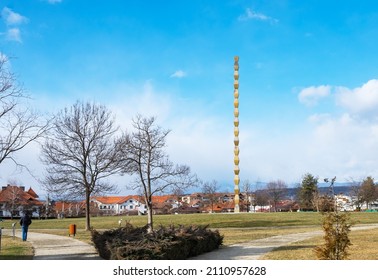 Walking in the park on a cold winter day. Endless Column Park in Targu Jiu. Endless column, the work of the famous Romanian sculptor, Constantin Brancusi. Romania, Tg.Jiu. January, 22, 2022