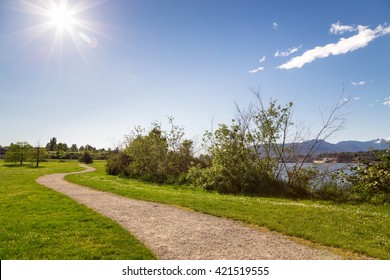 A Walking Path In A Ocean-side City Park On A Sunny Day. 