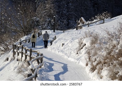 Walking path in the snow with two persons