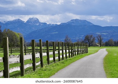 Walking path in spring. A path among the grass. Spring in a Bavarian village. A path for walking in spring on a sunny day.